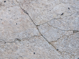 Gray concrete background texture. Cracks. Scratches. Damage.