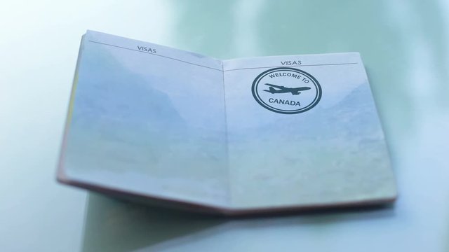 Welcome to Canada, customs officer hand stamping seal in passport, travel