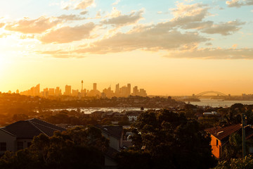 Magical glowing orange sunset over the skyline of Sydney with Harbour Bridge as seen on a summer...