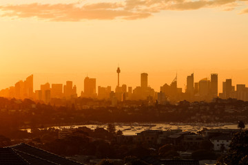 Close up of magical glowing orange sunset over the skyline of Sydney as seen on a summer evening from Dover Heights (Sydney, Australia)