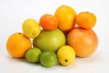 different citrus fruits on white background