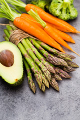 Bunch of fresh asparagus on wooden table.