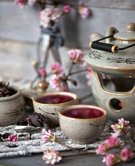 Cup of hot hibiscus tea and sepals