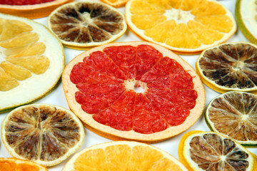 Naklejka na ściany i meble Dried slices of various citrus fruits on white background