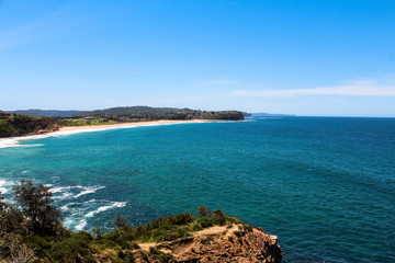 Turimetta Head Viewpoint looking towards Mona Vale Beach, one of Sydney's Northern beaches on a cloud-free summer day (Sydney, Australia)
