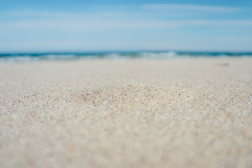 Fototapeta na wymiar Close-up of sandy beach with blue sea