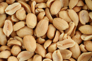 Food background - salted roasted peanuts situated arbitrarily