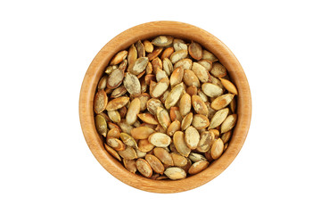Shelled  roasted pumpkin seeds in bamboo bowl on white background