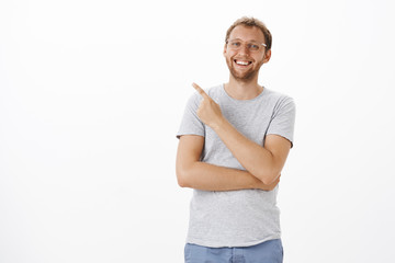 Portrait of upbeat carefree handsome european man with bristle in glasses smiling and laughing...