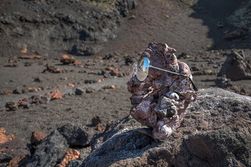 Lanzarote volcanic island of the Canary archipelago, Spain. The ancient solidified lava formations are reflected on the iconic objects of modern tourism