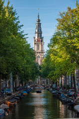 view over a canal in amsterdam - Zuiderkerk church in the background