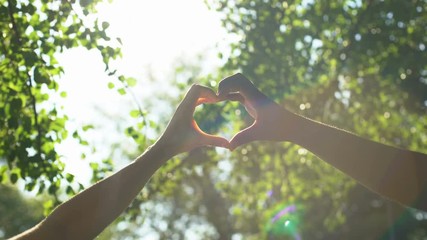 Multiracial couple hands in heart shape, interracial friendship, love and care - Powered by Adobe