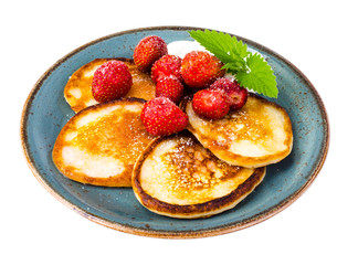 Delicious sweet fried pancakes with sugar and strawberries