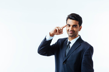 Portrait of a good looking businessman with one finger on his temples. isolated on white background
