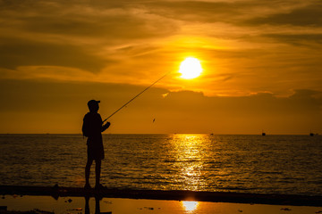 Fototapeta premium life portrait fishermen silhouette on the sea and the sunset over background evening time