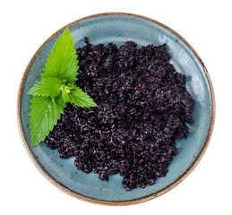 Cooked black rice on blue plate