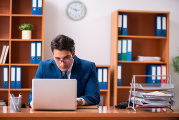 Young handsome businessman working in the office