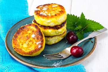 Hot fried delicious cheese cakes with powdered sugar