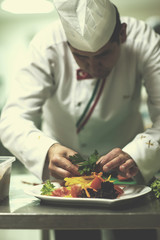 chef serving vegetable salad