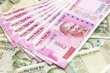 close up view of brand new 2000 indian rupees banknotes over 500 rupees banknotes background.