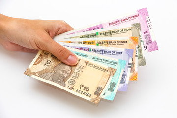 Female hands holding brand new 10, 50, 100, 200, 500 and 2000 indian rupees banknotes.
