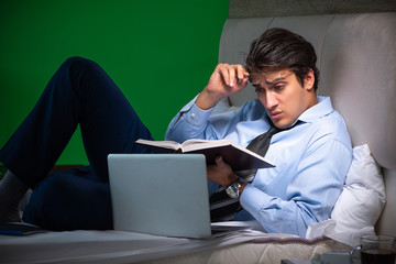 Young businessman under stress in the bedroom at night