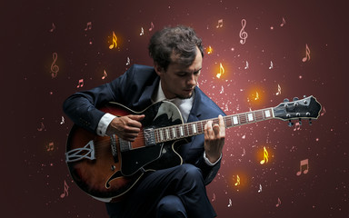 Young guitarist with falling musical notes wallpaper and classical concept