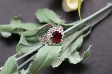 Red gem stone on silver ring with diamond