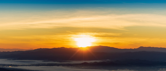Beautiful foggy winter sunrise in mountains of north Thailand.