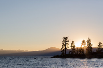 Sunset over Lake Tahoe with golden rays over water.