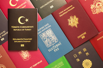  Brown biometric diplomatic passport of Turkey against the background of various documents of many countries of the world