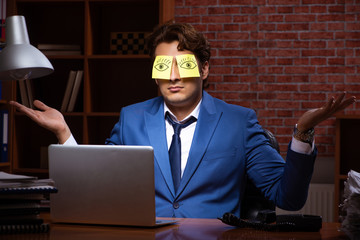 Young businessman working in the office at night 