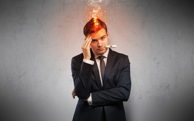 Fever businessman with burning head concept
