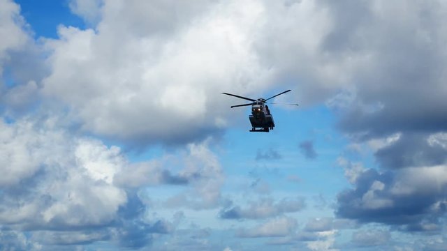 Helicopter heading and landing on an offshore oil rig , service travel to oil and gas platform and drilling rig in offshore locations