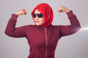 Muslim Lady in Red Shows Strong Muscle Gesture