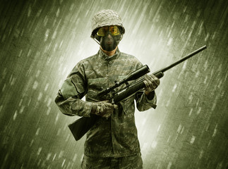 Armed soldier standing in rainy weather
