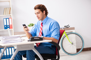 Young businessman using bike to commute to the office