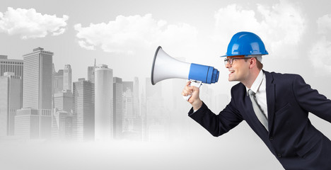Fototapeta premium Young supervisor architect yelling to far big city panorama 