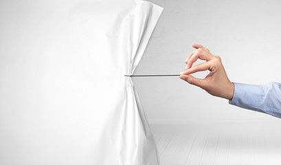 hand pulling white paper curtain, changing scene concept