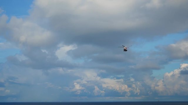 Helicopter heading and landing on an offshore oil rig , service travel to oil and gas platform and drilling rig in offshore locations