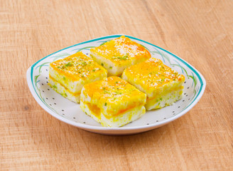 Paneer Burfi or Paneer Kesar Burfi is a Traditional Indian Mithai or Sweet Dish Prepared From Freshly Made Paneer, Mawa, Milk or Cottage Cheese on Wooden Background