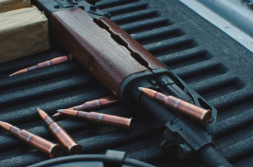 The bullets on the truck in the shooting range with the old rifle. 