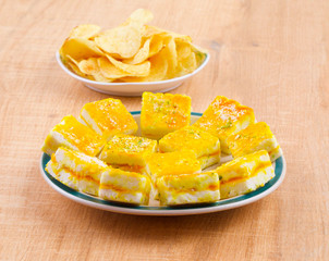 Paneer Burfi or Paneer Kesar Burfi is a Traditional Indian Mithai or Sweet Dish Prepared From Freshly Made Paneer, Mawa, Milk or Cottage Cheese on Wooden Background