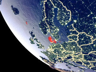 Orbit view of Denmark at night with bright city lights. Very detailed plastic planet surface.