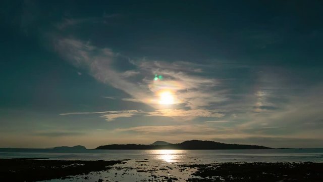 Time lapse of sun and clouds in the sky over tropical sea