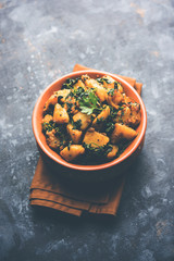 Fenugreek potato sabzi or Aloo Methi masala is healthy Indian Cuisine. served in a bowl or karahi. selective focus
