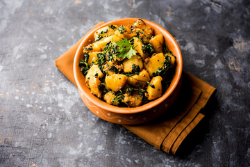 Fenugreek potato sabzi or Aloo Methi masala is healthy Indian Cuisine. served in a bowl or karahi. selective focus