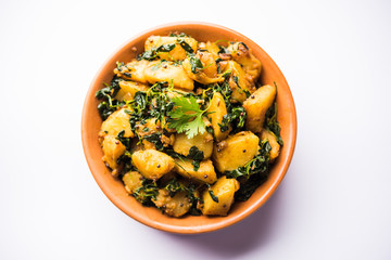 Fenugreek potato sabzi or Aloo Methi masala is healthy Indian Cuisine. served in a bowl or karahi. selective focus