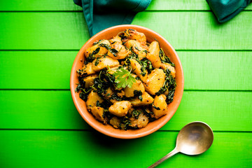 Fenugreek potato sabzi or Aloo Methi masala is healthy Indian Cuisine. served in a bowl or karahi....