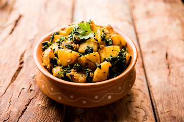 Fenugreek potato sabzi or Aloo Methi masala is healthy Indian Cuisine. served in a bowl or karahi. selective focus